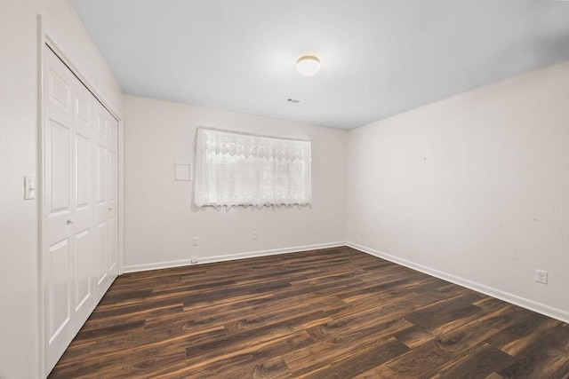 2001 Pin Oak Dr, Springdale, AR 72762 - unfurnished bedroom featuring a closet and dark wood-type flooring