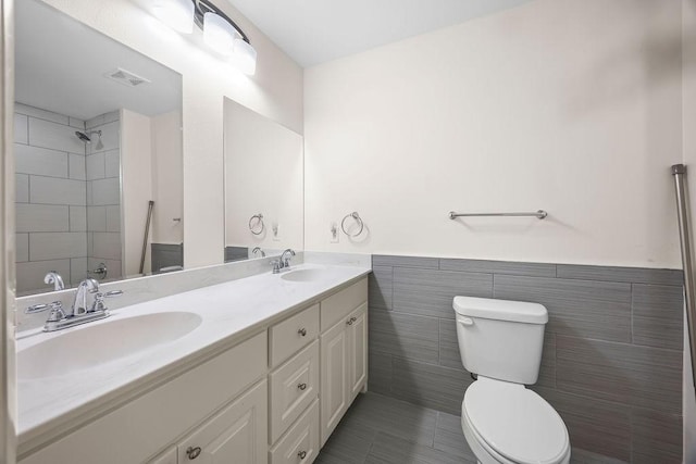 2001 Pin Oak Dr, Springdale, AR 72762 - full bath featuring double vanity, tile walls, a wainscoted wall, tile patterned floors, and a tile shower