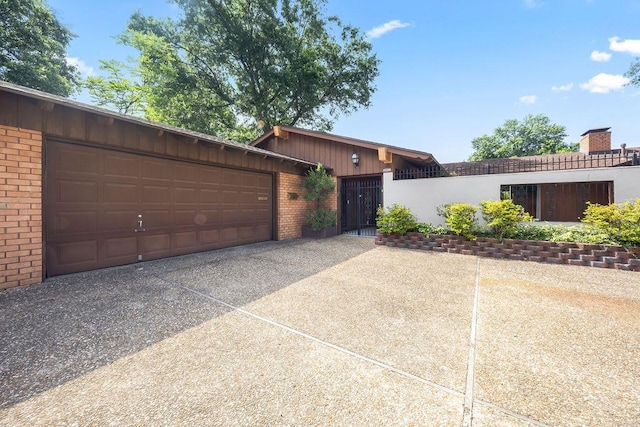 2001 Pin Oak Dr, Springdale, AR 72762 - view of front facade with brick siding, driveway, board and batten siding, and an attached garage