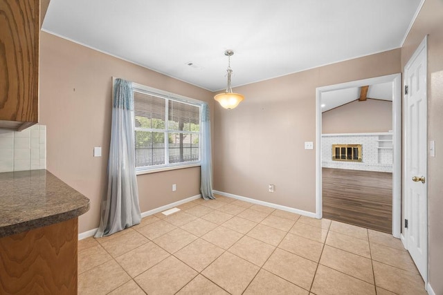 2001 Pin Oak Dr, Springdale, AR 72762 - unfurnished dining area featuring a brick fireplace and light tile patterned flooring