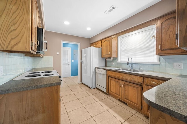2001 Pin Oak Dr, Springdale, AR 72762 - kitchen featuring white appliances, brown cabinets, tasteful backsplash, and dark countertops