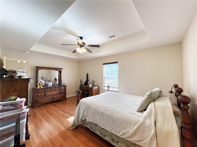 1459 Frisco Track Trce, Elkins, AR 72727 - bedroom with a raised ceiling, light wood-type flooring, and a ceiling fan