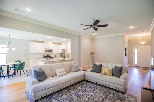 7655 Longspur Ave, Springdale, AR 72762 - living area featuring healthy amount of natural light, light wood-style flooring, recessed lighting, ceiling fan, and crown molding