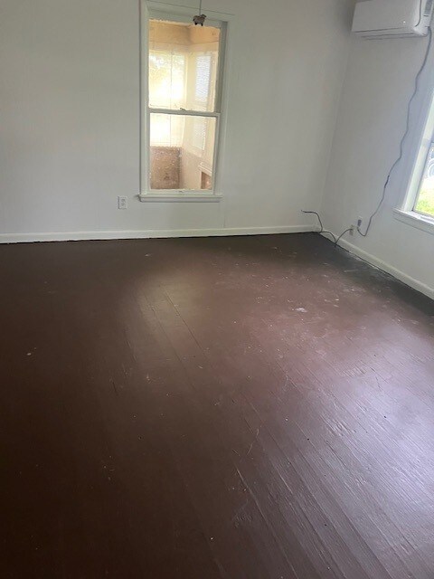 18588 W Rheas Community Rd, Lincoln, AR 72744 - spare room with hardwood / wood-style flooring and an AC wall unit
