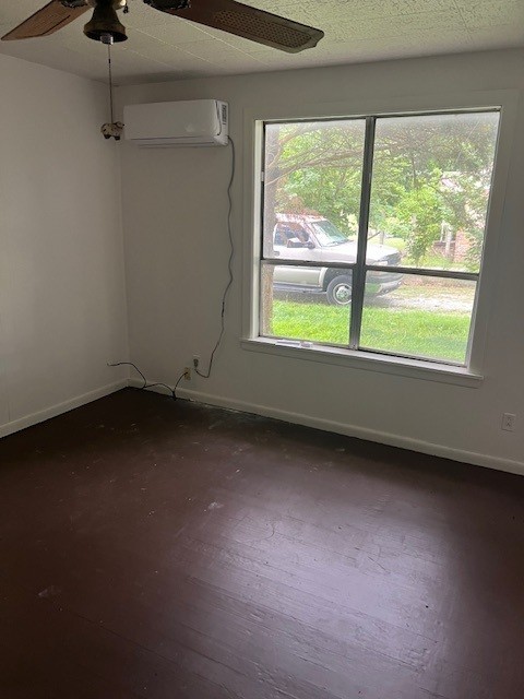 18588 W Rheas Community Rd, Lincoln, AR 72744 - unfurnished room featuring a wall mounted AC and a ceiling fan