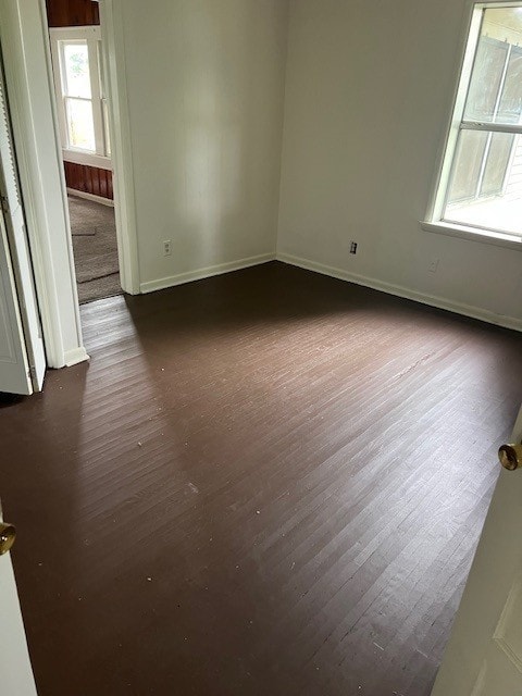 18588 W Rheas Community Rd, Lincoln, AR 72744 - empty room featuring dark wood finished floors and baseboards