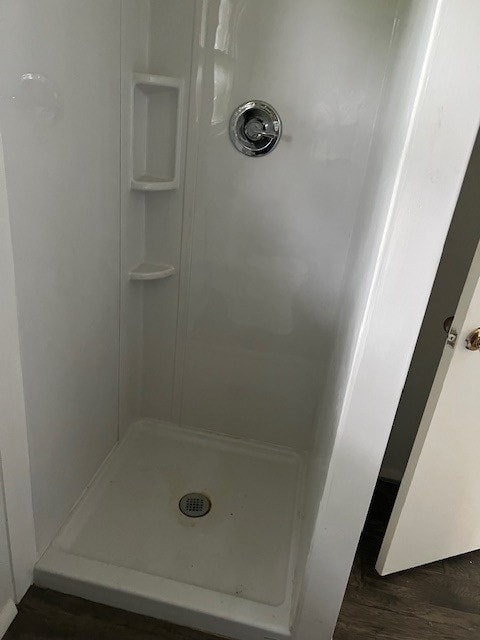 18588 W Rheas Community Rd, Lincoln, AR 72744 - bathroom featuring a stall shower and wood finished floors