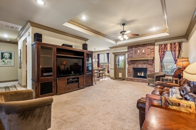 3004 N 16th St, Rogers, AR 72756 - living room with crown molding, a tray ceiling, ceiling fan, a brick fireplace, and light carpet