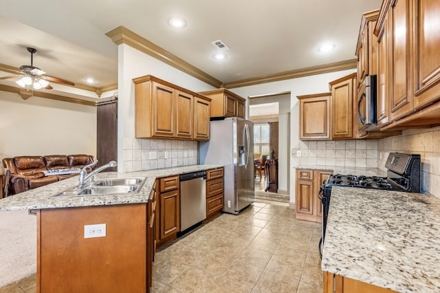 3004 N 16th St, Rogers, AR 72756 - kitchen with appliances with stainless steel finishes, crown molding, a peninsula, ceiling fan, and brown cabinetry