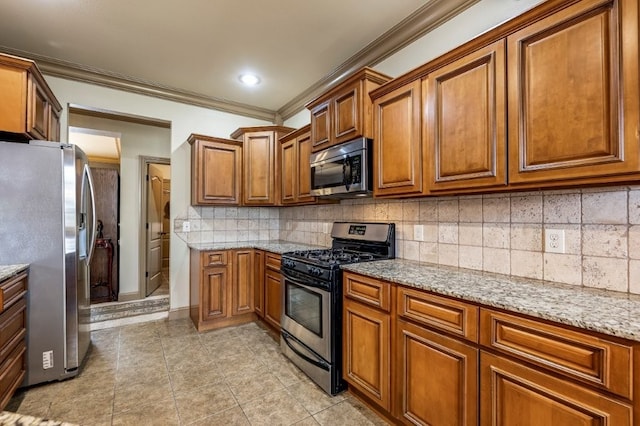 3004 N 16th St, Rogers, AR 72756 - kitchen featuring appliances with stainless steel finishes, brown cabinetry, ornamental molding, light tile patterned floors, and light stone counters