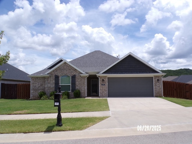 298 S Benchmark Ln, Fayetteville, AR 72704 - view of front of home featuring an attached garage, concrete driveway, brick siding, and a shingled roof