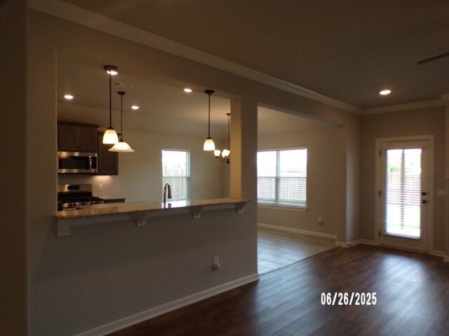 298 S Benchmark Ln, Fayetteville, AR 72704 - kitchen featuring stainless steel appliances, a breakfast bar, recessed lighting, dark wood-type flooring, and a peninsula