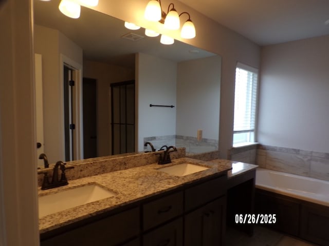 298 S Benchmark Ln, Fayetteville, AR 72704 - full bath featuring a bath, double vanity, and a chandelier