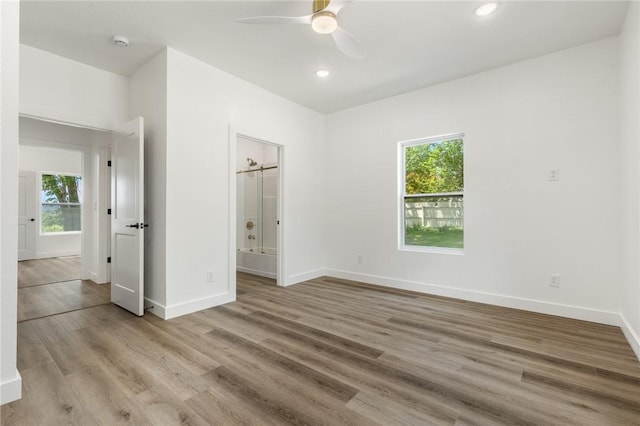 1348 Columbine Cv, Harrison, AR 72601 - unfurnished bedroom with multiple windows, wood finished floors, recessed lighting, ensuite bathroom, and a ceiling fan