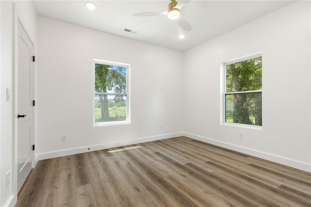 1348 Columbine Cv, Harrison, AR 72601 - empty room with healthy amount of natural light, wood finished floors, a ceiling fan, and recessed lighting
