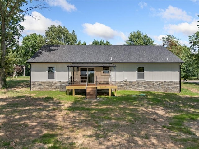1348 Columbine Cv, Harrison, AR 72601 - rear view of house with a wooden deck, stone siding, and a lawn