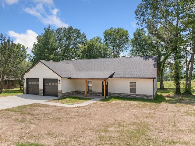 1348 Columbine Cv, Harrison, AR 72601 - view of front of house featuring stone siding, concrete driveway, an attached garage, and a front lawn