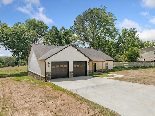1348 Columbine Cv, Harrison, AR 72601 - modern farmhouse style home with a garage, stone siding, concrete driveway, and a shingled roof