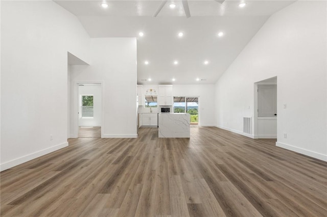 1348 Columbine Cv, Harrison, AR 72601 - unfurnished living room with high vaulted ceiling and light wood-style flooring