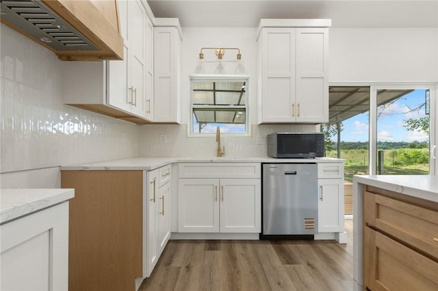 1348 Columbine Cv, Harrison, AR 72601 - kitchen featuring dishwasher, black microwave, range hood, light wood-style floors, and decorative backsplash