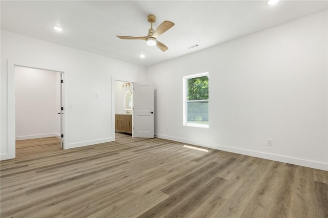 1348 Columbine Cv, Harrison, AR 72601 - unfurnished bedroom with light wood-style floors, recessed lighting, a spacious closet, and ceiling fan