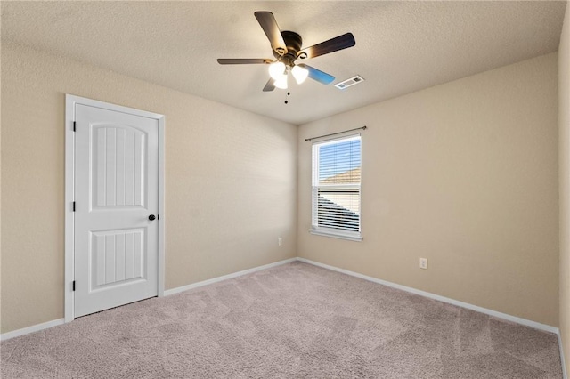 2504 Maplewood Ave, Lowell, AR 72745 - carpeted spare room with a ceiling fan and a textured ceiling