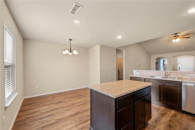 2504 Maplewood Ave, Lowell, AR 72745 - kitchen with dishwasher, a kitchen island, light wood finished floors, a chandelier, and arched walkways