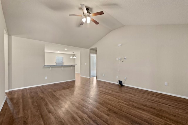 2504 Maplewood Ave, Lowell, AR 72745 - unfurnished living room with a ceiling fan, vaulted ceiling, and dark wood-style flooring