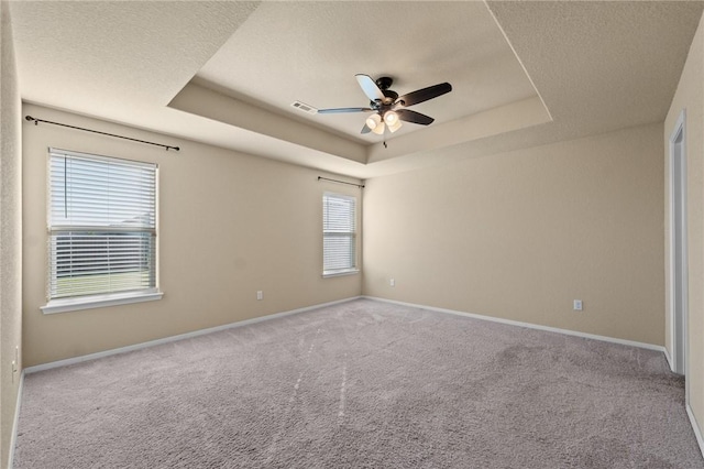 2504 Maplewood Ave, Lowell, AR 72745 - carpeted empty room featuring a raised ceiling, ceiling fan, and a textured ceiling