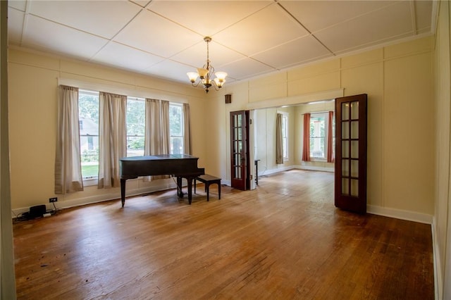 501 Fillmore St, Clarksville, AR 72830 - sitting room with french doors, a chandelier, and hardwood / wood-style flooring