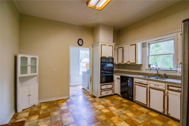 501 Fillmore St, Clarksville, AR 72830 - kitchen featuring black appliances, white cabinets, and dark countertops