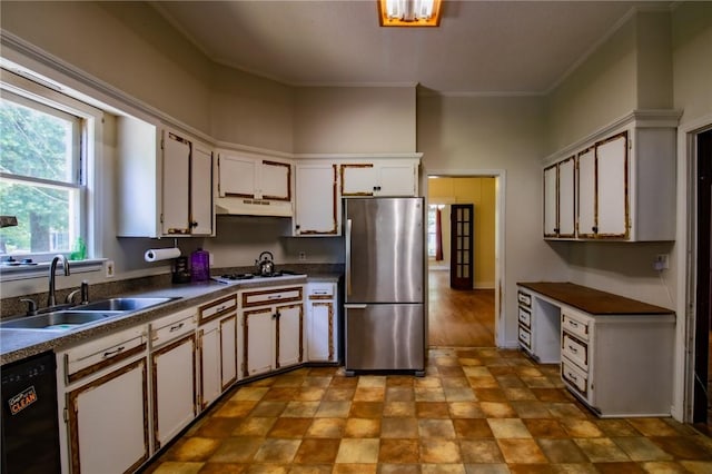 501 Fillmore St, Clarksville, AR 72830 - kitchen with freestanding refrigerator, under cabinet range hood, dishwasher, dark countertops, and white cabinetry