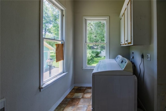 501 Fillmore St, Clarksville, AR 72830 - laundry room featuring cabinet space, washer and clothes dryer, and stone finish floors