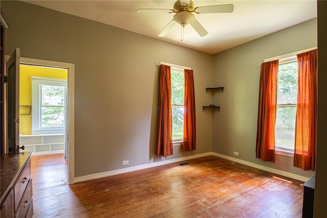 501 Fillmore St, Clarksville, AR 72830 - spare room featuring wood finished floors, plenty of natural light, and a ceiling fan
