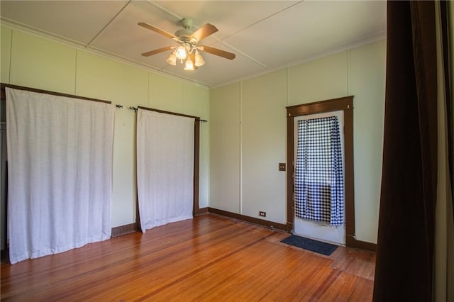 501 Fillmore St, Clarksville, AR 72830 - unfurnished bedroom with wood finished floors, a ceiling fan, and crown molding