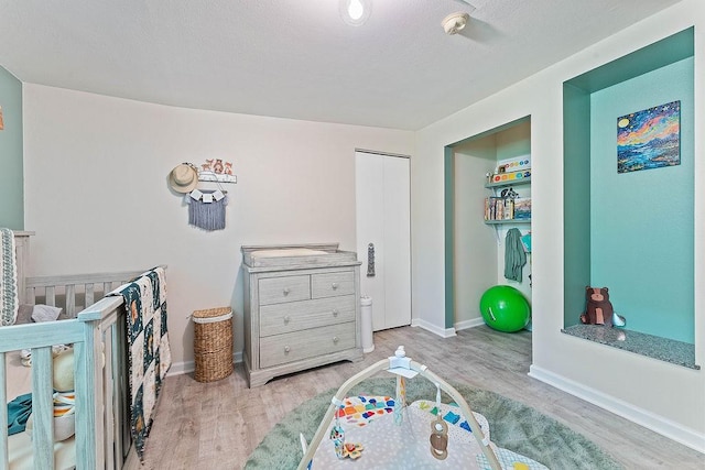 3389 Madison Unit 2405, Huntsville, AR 72740 - bedroom featuring wood finished floors and a nursery area