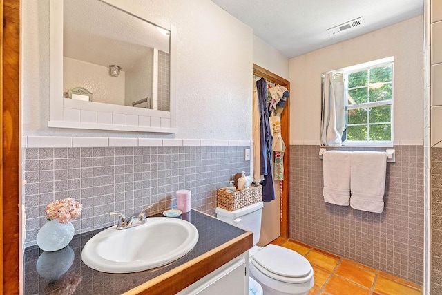3389 Madison Unit 2405, Huntsville, AR 72740 - bathroom with tile walls, tile patterned floors, a wainscoted wall, and vanity