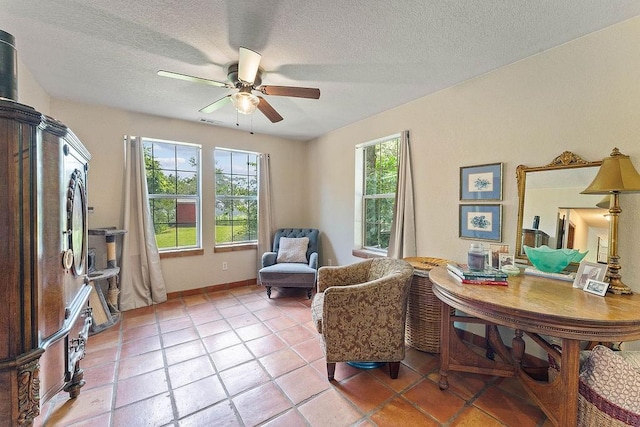 3389 Madison Unit 2405, Huntsville, AR 72740 - living area featuring a ceiling fan, a textured ceiling, and light tile patterned floors