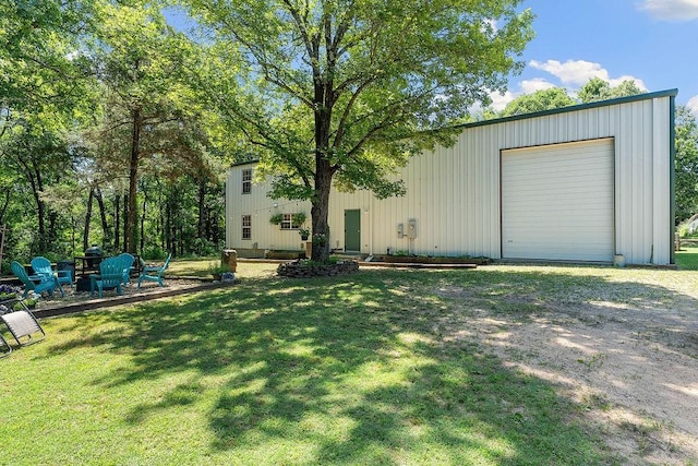 3389 Madison Unit 2405, Huntsville, AR 72740 - view of green lawn with an outdoor structure, a garage, and driveway