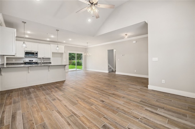 20 Dirleton Dr, Bella Vista, AR 72715 - kitchen featuring stainless steel appliances, dark countertops, recessed lighting, white cabinets, and open floor plan