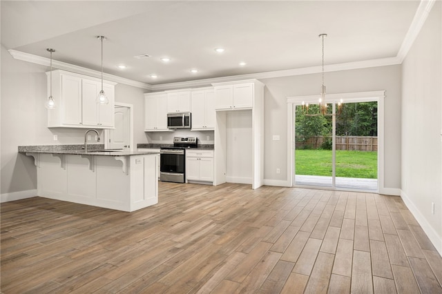 20 Dirleton Dr, Bella Vista, AR 72715 - kitchen featuring appliances with stainless steel finishes, a peninsula, white cabinets, ornamental molding, and light wood finished floors