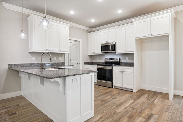 20 Dirleton Dr, Bella Vista, AR 72715 - kitchen featuring appliances with stainless steel finishes, a peninsula, dark stone countertops, white cabinets, and light wood-style floors
