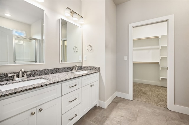 20 Dirleton Dr, Bella Vista, AR 72715 - full bath with double vanity, a spacious closet, and a shower with shower door