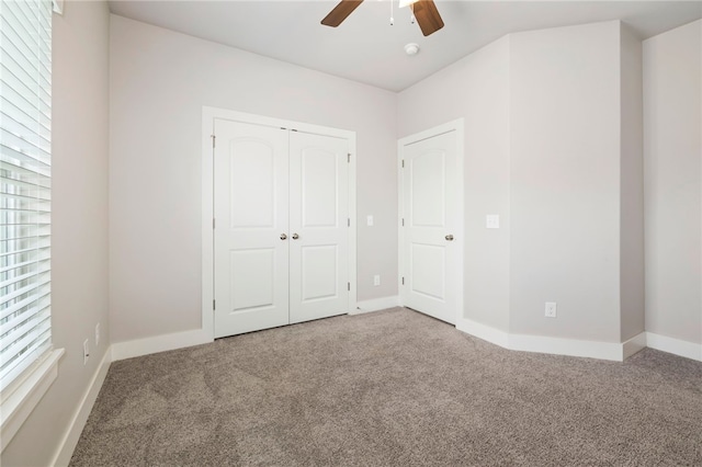 1052 Morra Ave, Tontitown, AR 72762 - unfurnished bedroom featuring carpet, a closet, and a ceiling fan