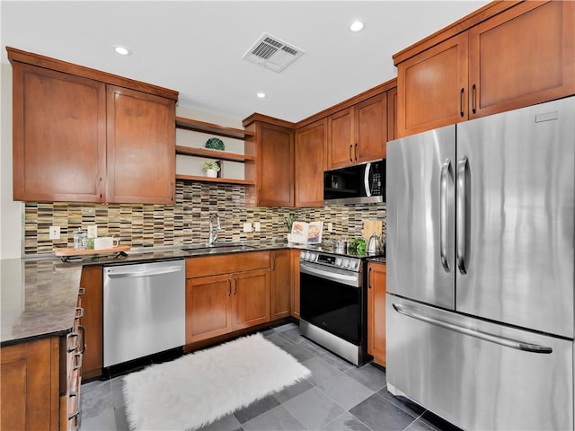401 W Watson St Unit 507, Fayetteville, AR 72701 - kitchen featuring appliances with stainless steel finishes, open shelves, tasteful backsplash, brown cabinetry, and recessed lighting