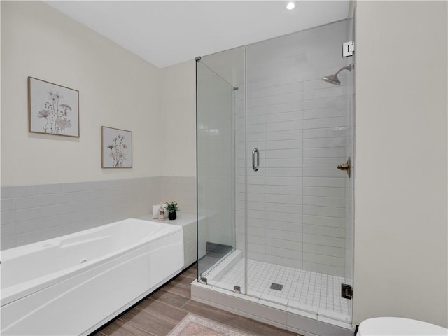 401 W Watson St Unit 507, Fayetteville, AR 72701 - full bathroom featuring a shower stall, a garden tub, wood finished floors, and recessed lighting
