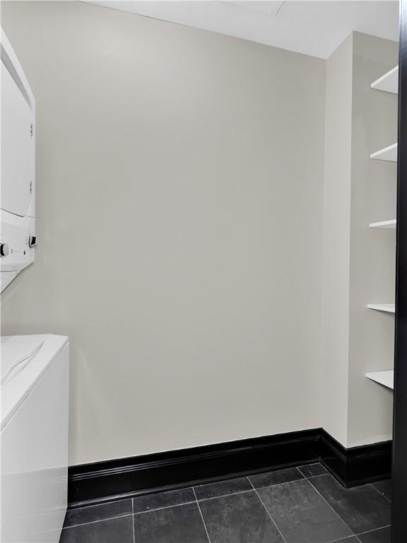 401 W Watson St Unit 507, Fayetteville, AR 72701 - washroom featuring estacked washer and dryer and baseboards