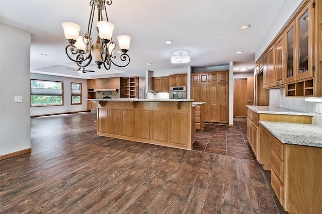 1 May Ln, Bella Vista, AR 72715 - kitchen featuring brown cabinetry, stainless steel oven, a chandelier, dark wood-style floors, and recessed lighting