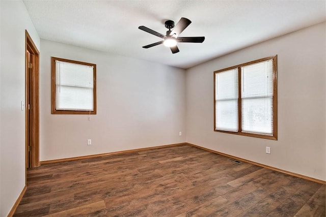 1 May Ln, Bella Vista, AR 72715 - unfurnished room featuring healthy amount of natural light, dark wood-style floors, and a ceiling fan
