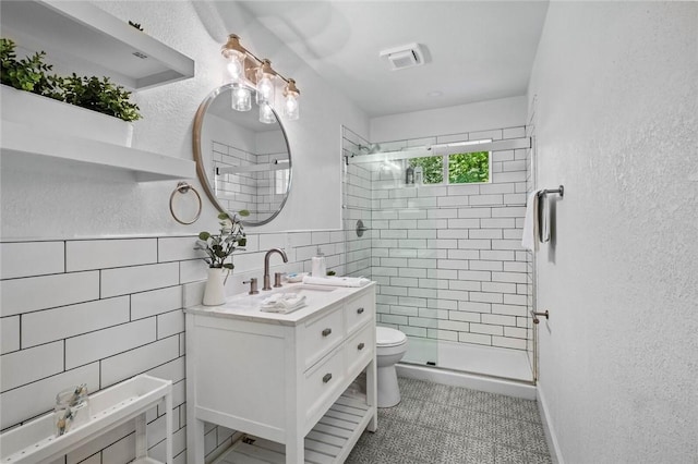 1115-1117 S Ellis Ave, Fayetteville, AR 72701 - full bath with vanity, a textured wall, a shower stall, tile walls, and tile patterned floors